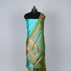 Teal Green Banarasi Handloom Luxury Suit set contrast with Deep Dhani Green color.
